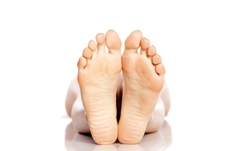female bare feet on white backgroundの写真素材