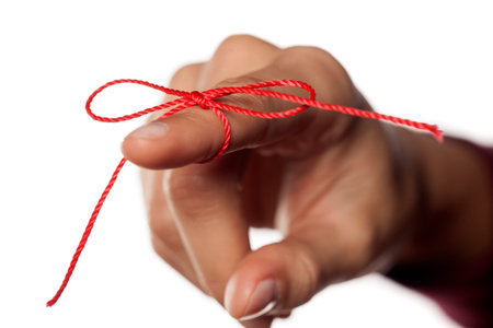 index finger tied with a red rope