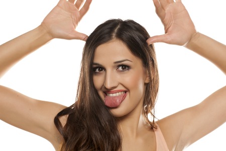 funny young woman shows her tongueの写真素材