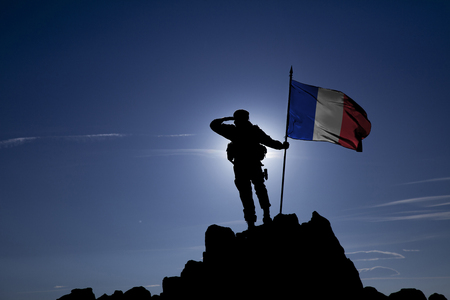 Soldier on top of the mountain with the French flagの写真素材