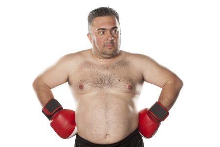 amazed naked fat man posing with boxing glovesの写真素材