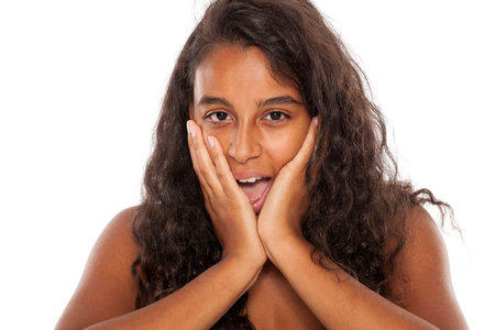 amazed dark skinned beautiful girl on white backgroundの写真素材
