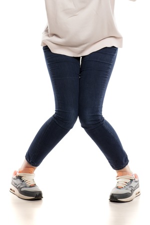 Confused an happy young woman on white backgroundの写真素材