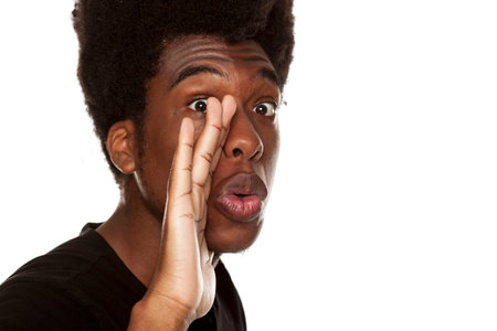 young handsome afro american hipster guy whispering isolated on white background. people gossip...