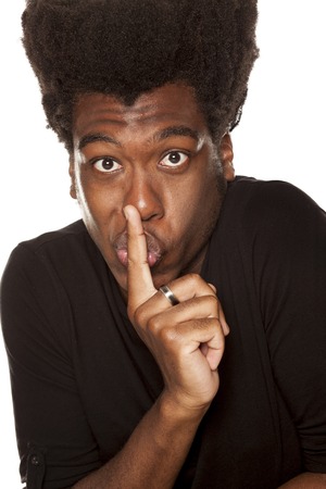 young handsome afro american hipster guy with finger over the lips isolated on white background. silent conceptの写真素材
