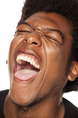 Very happy african american young man with funny face on white backgroundの写真素材