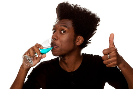 young handsome afro american guy drinks a blue wine isolated on white background. lifestile concept