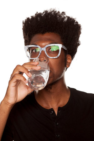 Portrait of young african american man drinking water from a glass  on white background