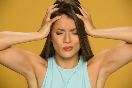 Young beautiful woman with headacheの写真素材