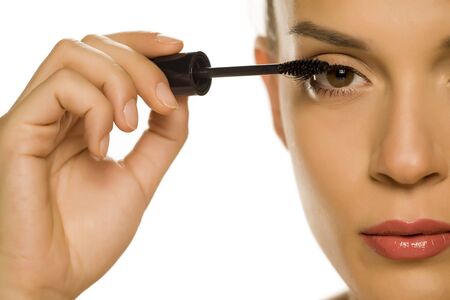 woman applying mascara on her eyelashesの写真素材