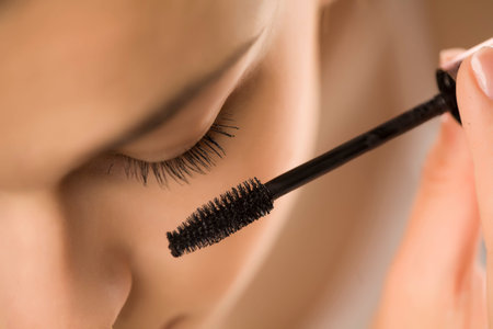 closeup of woman applyinhg mascara on her eyelashes