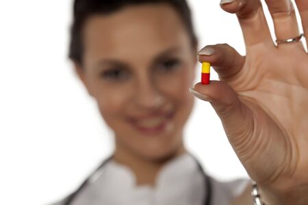 a young woman doctor holding a capsuleの写真素材