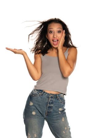 Happy dark skinned woman holding imaginary object on white backgroundの写真素材