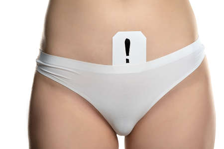 a woman in white panties and an exclamation mark drawn on paper on a white backgroundの写真素材