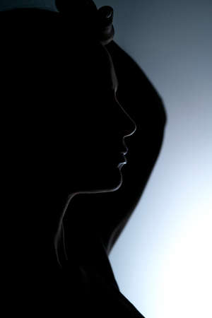 profile silhouette of a beautiful woman on a gray backgroundの写真素材