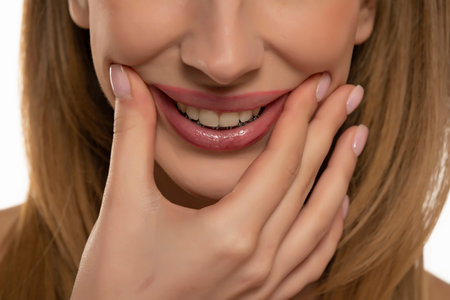 cropped portrait of young woman stretching mouth in fake smile with her fingers