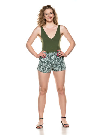 a woman in a summer shorts and shirt on a white background, front viewの写真素材