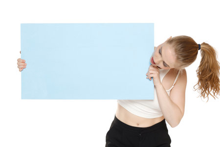Banner of young blonde woman feeling happiness and holding blue Empty white canvas frame for text or advertising isolated on white studio backgroundの写真素材