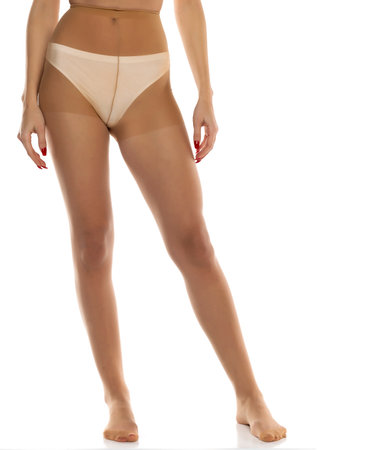 Woman wearing tights isolated on white, closeup of legs on a white studio background. Front viewの写真素材