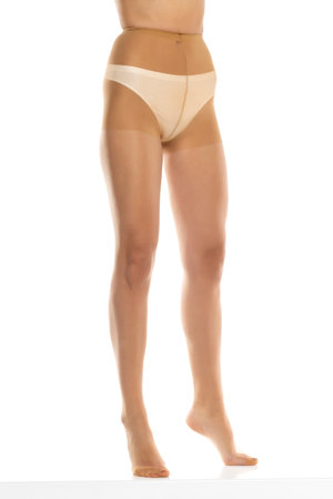 Woman wearing tights isolated on white, closeup of legs on a white studio background. Front viewの写真素材