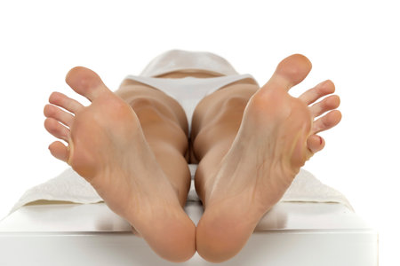 Close up of a female soles with outstretched toes on a white studio  backgroundの写真素材