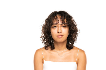 portrait of beautiful young indian woman without makeup on a white studio backgroundの写真素材