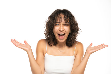 portrait of beautiful young indian happy woman without makeup on a white studio backgroundの写真素材