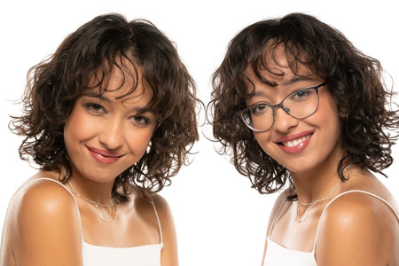 Collage of a young dark skinned smiling woman with makeup and wavy hair posing with, and withour glasses on a white studio backgroundの写真素材