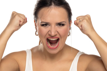 Nervous woman screams yell shout on a white studio backgroundの写真素材