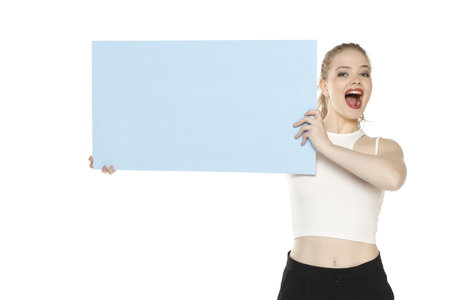 Banner of young happy blonde woman feeling happiness and holding blue Empty white canvas frame for text or advertising isolated on white studio backgroundの写真素材