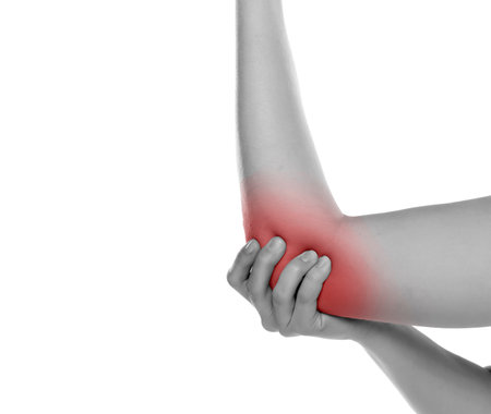 Cropped image woman with joint inflammation. Female's elbow on a white studio backgroundの写真素材