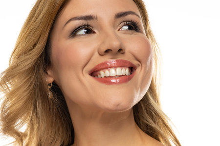 A captivating portrait of a stunning woman showcasing her flawless, natural teeth and a self-assured smile radiating positivity and healthの写真素材