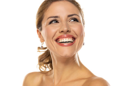 A captivating portrait of a stunning woman showcasing her flawless, natural teeth and a self-assured smile radiating positivity and healthの写真素材
