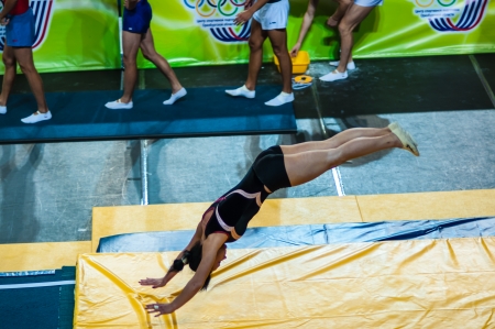 The city of Orenburg, Orenburg oblast, Russia, August 24, 2013. Russian Championship on the jumps on trampoline. The girl on the acrobatic trackのeditorial素材