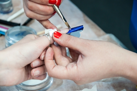 Woman in a nail salon receiving manicureの写真素材