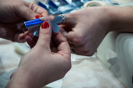 Woman in a nail salon receiving manicureの写真素材