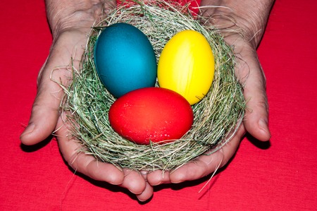 Easter egg in the hands of an elderly person for the feast of the radiant resurrection of Christの写真素材