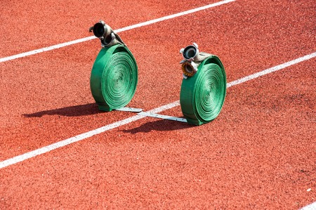 Fire hose is a flexible pipe for conveying fire-extinguishing agents, equipped firefighters connecting headsの写真素材