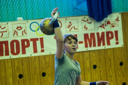 ORENBURG, ORENBURG region, RUSSIA, 31 October, 2014 year. City tournament on weight lifting among boys and girls, dedicated to the memory of Bolshakova. The girl in the kettlebell sportのeditorial素材