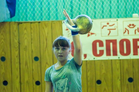ORENBURG, ORENBURG region, RUSSIA, 31 October, 2014 year. City tournament on weight lifting among boys and girls, dedicated to the memory of Bolshakova. The girl in the kettlebell sportのeditorial素材