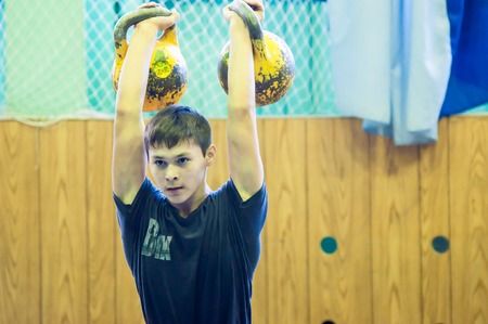 ORENBURG, ORENBURG region, RUSSIA, 31 October, 2014 year. City tournament on weight lifting among boys and girls, dedicated to the memory of Bolshakova. The boy in the kettlebell sportのeditorial素材