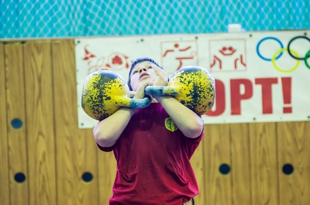 ORENBURG, ORENBURG region, RUSSIA, 31 October, 2014 year. City tournament on weight lifting among boys and girls, dedicated to the memory of Bolshakova. The boy in the kettlebell sportのeditorial素材