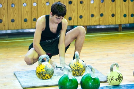 ORENBURG, ORENBURG region, RUSSIA, 31 October, 2014 year. City tournament on weight lifting among boys and girls, dedicated to the memory of Bolshakova. The boy in the kettlebell sportのeditorial素材