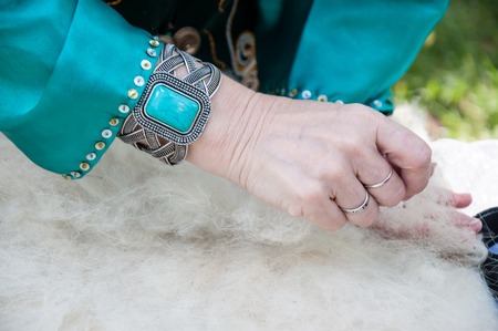 The hands of a Muslim woman working with woolの写真素材