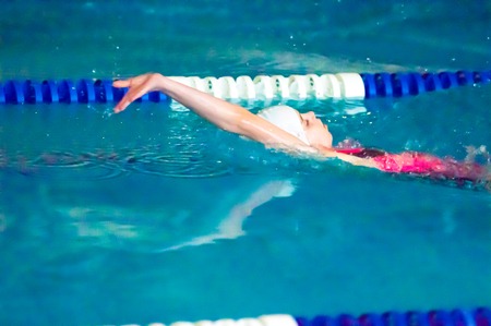 ORENBURG, ORENBURG region, RUSSIA, 21 November, 2014 year. Outdoor city tournament on swimming "Autumn starts" in the city of Orenburg administration prizes. Girl backstrokeのeditorial素材