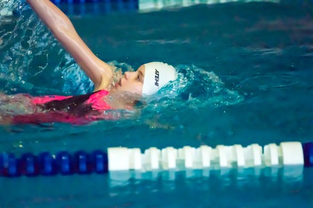 ORENBURG, ORENBURG region, RUSSIA, 21 November, 2014 year. Outdoor city tournament on swimming "Autumn starts" in the city of Orenburg administration prizes. Girl backstrokeのeditorial素材