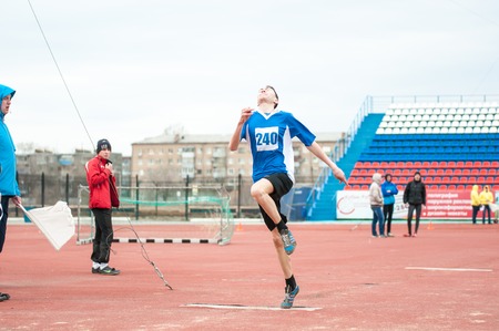 Orenburg, Russia - 24 April 2015: Men compete in long jump on the sports contest students of institutions of secondary vocational education "Youth of the Orenburga"のeditorial素材
