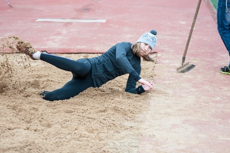 Orenburg, Russia - 24 April 2015: Girl performs a long jump on the sports contest students of institutions of secondary vocational education "Youth of the Orenburga"のeditorial素材