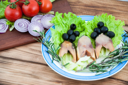 Smoked fish with fresh herbs on the old wooden countertopの写真素材