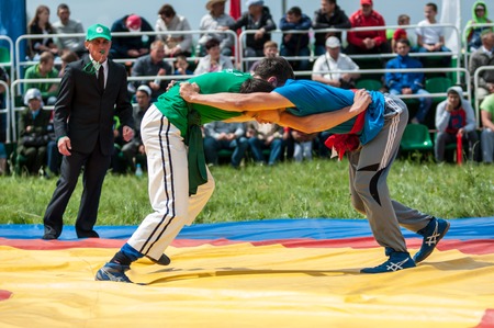 Orenburg, Russia - 7 June 2015: Wrestling on belts or Koresh on Sabantuy Festival